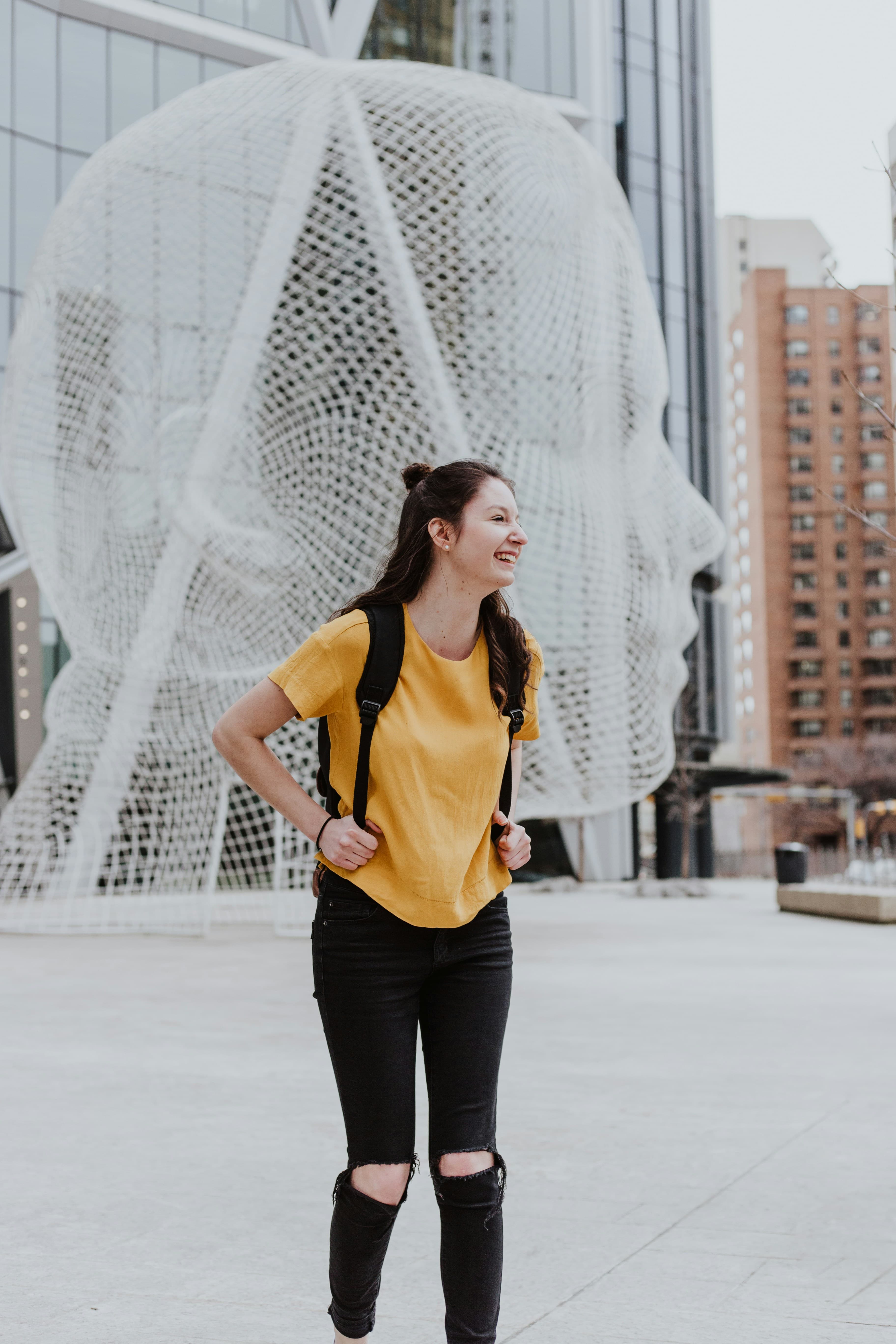 Happy student with backpack exploring a European city